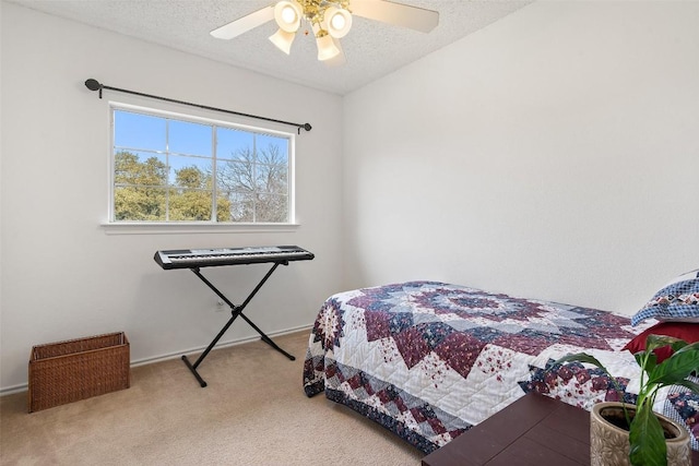 carpeted bedroom featuring ceiling fan and a textured ceiling