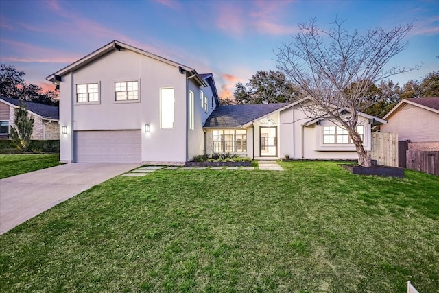 front facade with a garage and a lawn