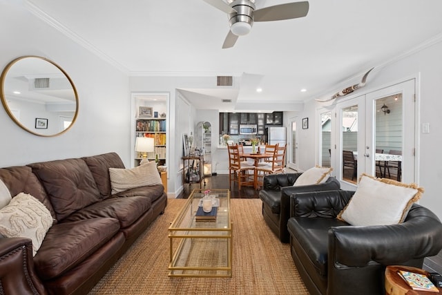 living room with french doors, crown molding, ceiling fan, and wood-type flooring