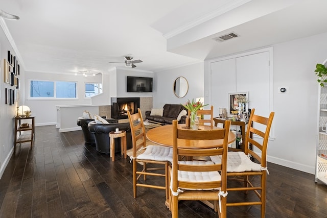 dining area featuring crown molding, dark hardwood / wood-style flooring, and ceiling fan