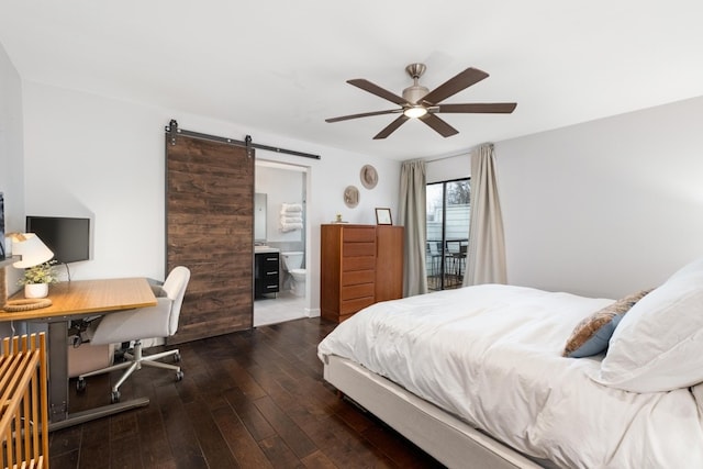 bedroom with ensuite bathroom, ceiling fan, dark hardwood / wood-style flooring, and a barn door