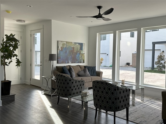 living room featuring wood-type flooring and ceiling fan