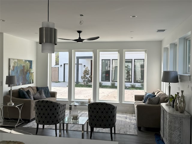 living room featuring ceiling fan and hardwood / wood-style floors