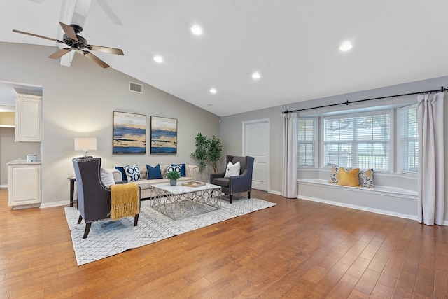 living room with vaulted ceiling, ceiling fan, and light hardwood / wood-style floors
