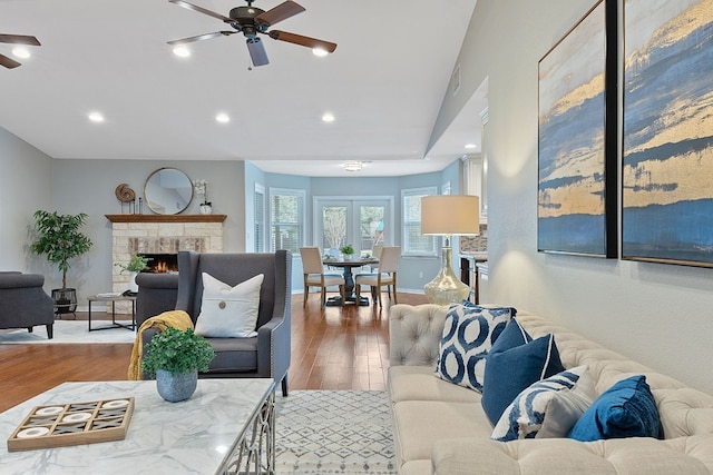 living room featuring ceiling fan and hardwood / wood-style floors