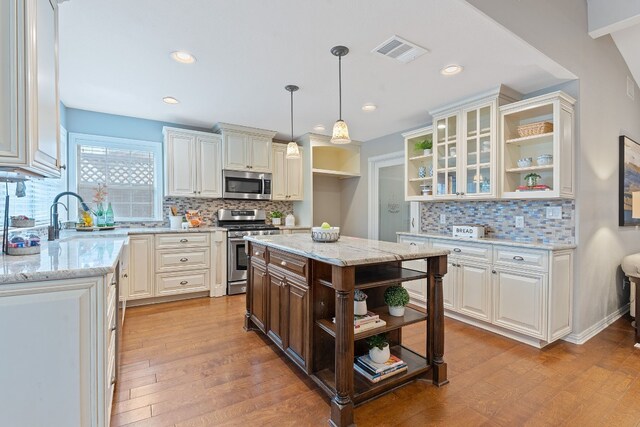 1526 Shenandoah Dr, Cedar Park, TX 78613 - kitchen with open shelves, appliances with stainless steel finishes, decorative backsplash, light wood-type flooring, and recessed lighting