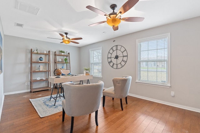 dining room with hardwood / wood-style flooring and ceiling fan
