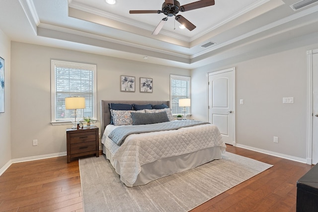 bedroom featuring crown molding, ceiling fan, a tray ceiling, and hardwood / wood-style floors