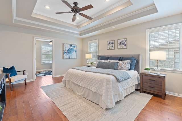 1526 Shenandoah Dr, Cedar Park, TX 78613 - bedroom featuring a raised ceiling, crown molding, multiple windows, hardwood / wood-style floors, and baseboards