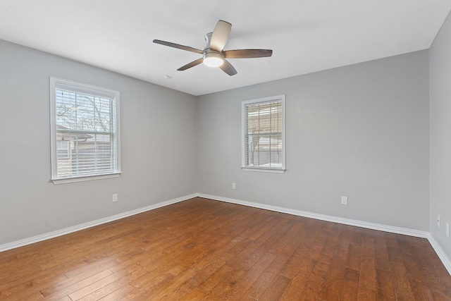 spare room featuring hardwood / wood-style flooring, a healthy amount of sunlight, and ceiling fan