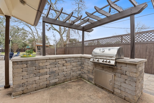 view of patio / terrace with a pergola, grilling area, and an outdoor kitchen