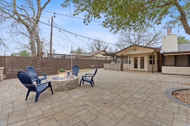 1526 Shenandoah Dr, Cedar Park, TX 78613 - fenced backyard with french doors, an outdoor fire pit, and a patio area