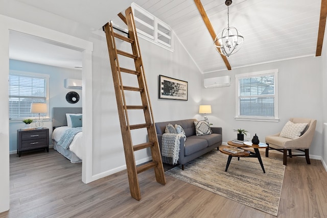 living room with hardwood / wood-style flooring, an AC wall unit, plenty of natural light, and lofted ceiling with beams
