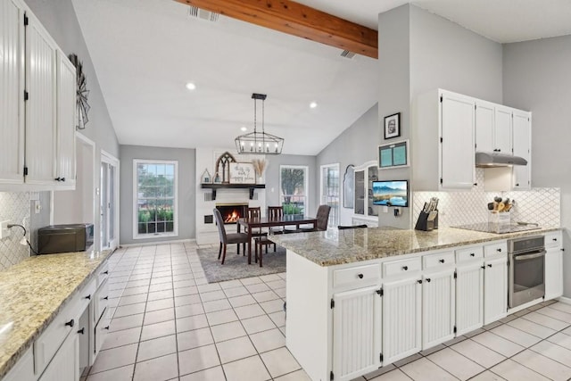 kitchen with visible vents, beam ceiling, oven, under cabinet range hood, and black electric cooktop