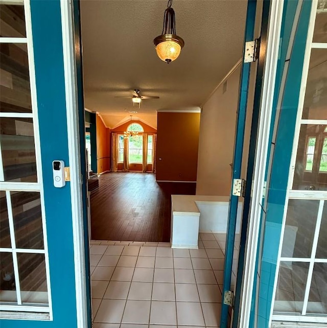 corridor with tile patterned floors and vaulted ceiling
