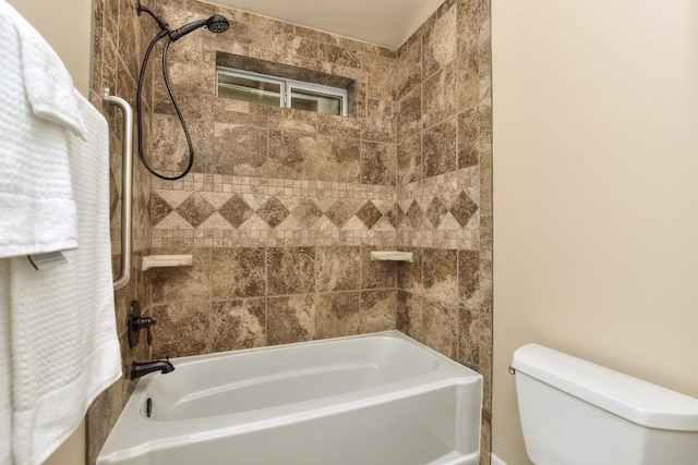 bathroom featuring tiled shower / bath and toilet