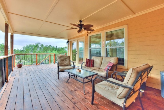 wooden terrace with an outdoor living space and ceiling fan