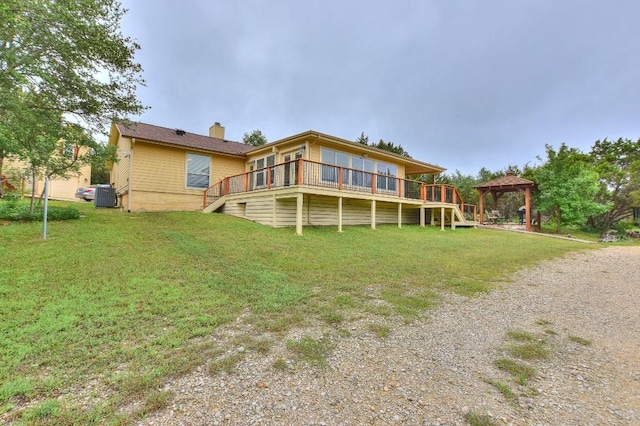 back of property featuring a gazebo, a yard, and central AC unit