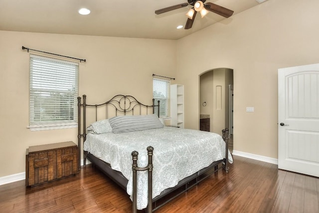 bedroom featuring dark wood-type flooring, vaulted ceiling, and ceiling fan