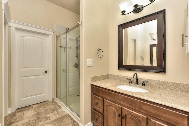 bathroom featuring vanity and a shower with shower door