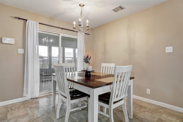dining space with visible vents, baseboards, and an inviting chandelier
