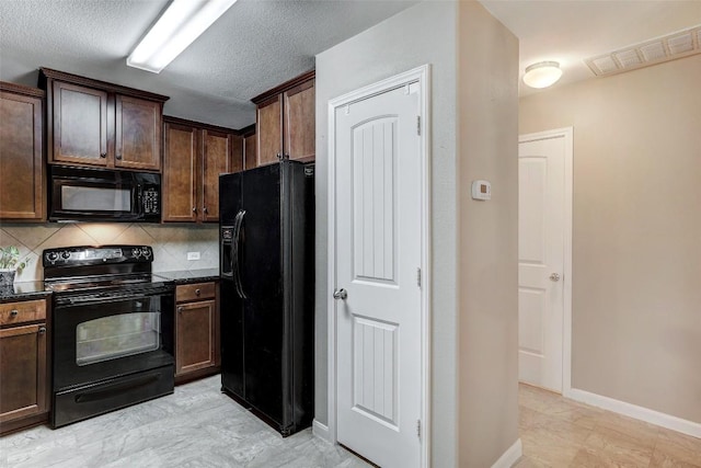 kitchen featuring dark brown cabinetry, baseboards, tasteful backsplash, visible vents, and black appliances