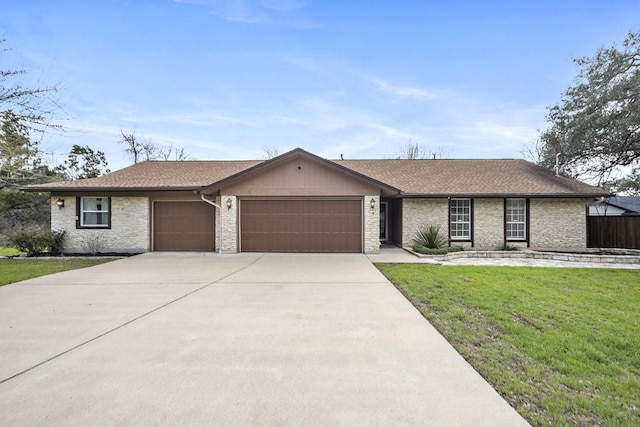 ranch-style house with a garage and a front lawn