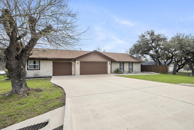 ranch-style house featuring a garage and a front yard