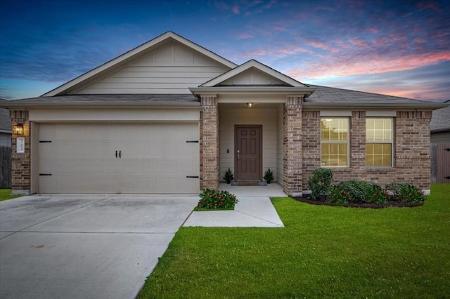 view of front of property featuring a yard and a garage