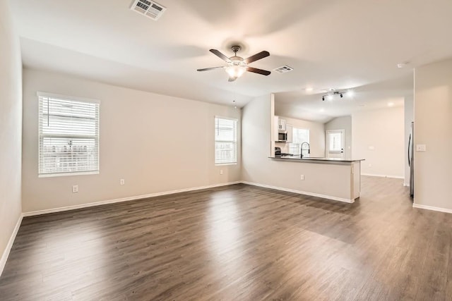 10801 Dimitrios Dr, Austin, TX 78747 - unfurnished living room featuring dark wood-type flooring and a ceiling fan