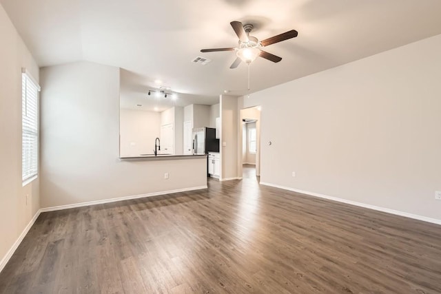 10801 Dimitrios Dr, Austin, TX 78747 - unfurnished living room with ceiling fan, dark wood-style flooring, and healthy amount of natural light