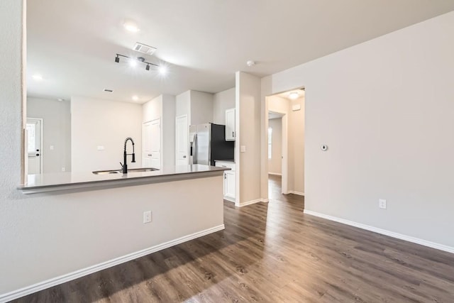 10801 Dimitrios Dr, Austin, TX 78747 - kitchen with stainless steel refrigerator with ice dispenser, white cabinets, dark wood-style floors, and a peninsula