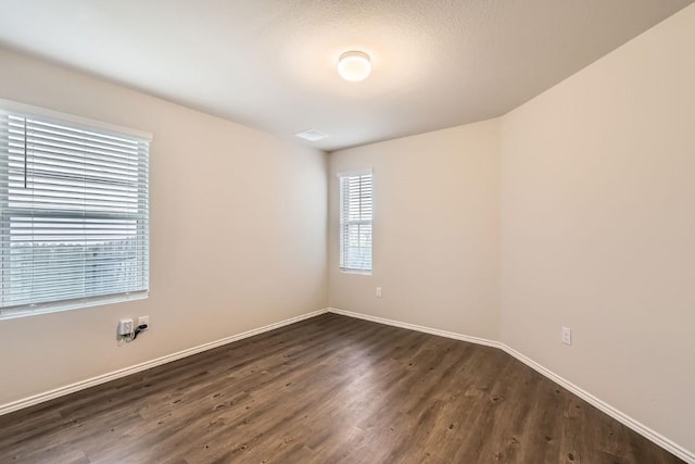 10801 Dimitrios Dr, Austin, TX 78747 - spare room with dark wood finished floors and baseboards