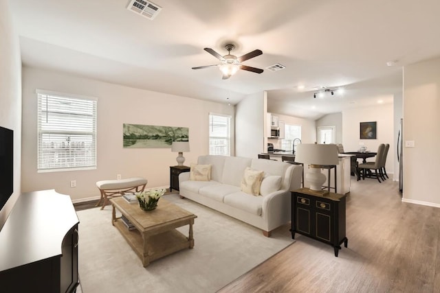 10801 Dimitrios Dr, Austin, TX 78747 - living room with light wood-style floors and a ceiling fan