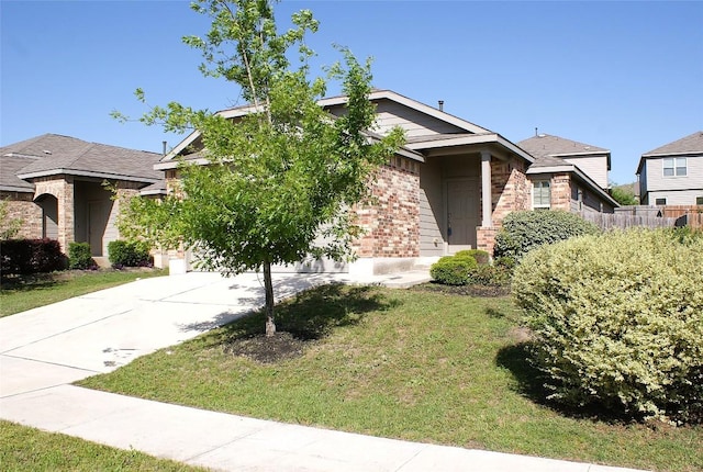 10801 Dimitrios Dr, Austin, TX 78747 - view of front of home with driveway, brick siding, and an attached garage