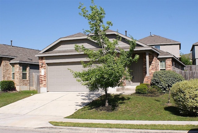 10801 Dimitrios Dr, Austin, TX 78747 - view of front of home featuring concrete driveway, brick siding, and an attached garage