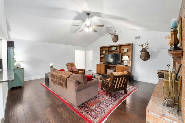 living area with dark wood-type flooring, a fireplace, visible vents, and ceiling fan