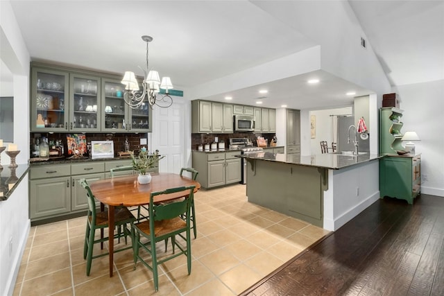 dining room featuring recessed lighting, baseboards, a chandelier, and light tile patterned floors