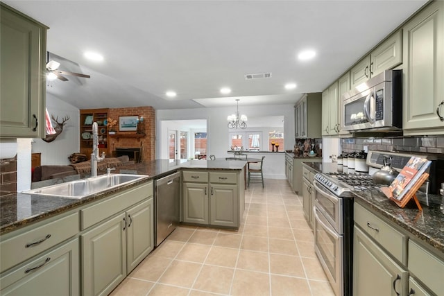 kitchen with tasteful backsplash, visible vents, green cabinets, light tile patterned floors, and stainless steel appliances