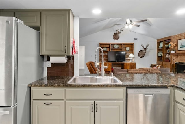 kitchen with a ceiling fan, open floor plan, appliances with stainless steel finishes, and a sink