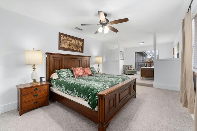 bedroom with visible vents, baseboards, light colored carpet, and a ceiling fan