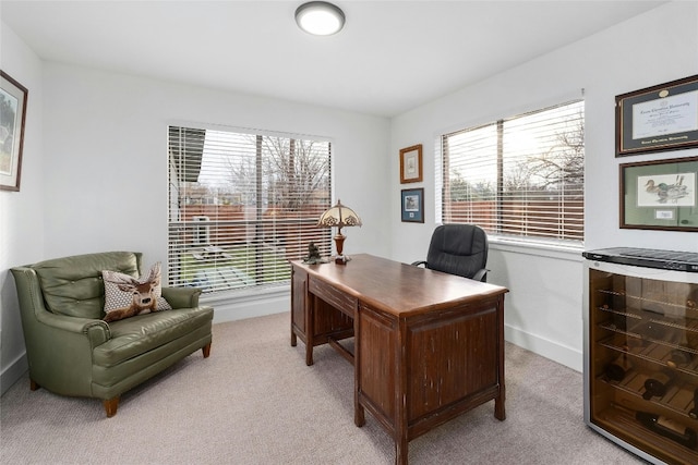 office with baseboards, wine cooler, and light carpet