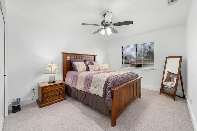 bedroom featuring visible vents, light carpet, baseboards, and a ceiling fan