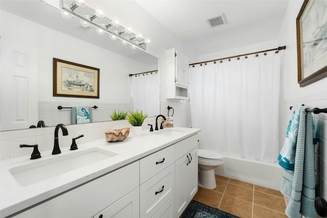 full bathroom with a sink, visible vents, double vanity, and tile patterned floors