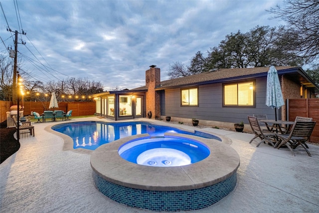 view of swimming pool featuring a fenced in pool, a patio, an in ground hot tub, and a fenced backyard