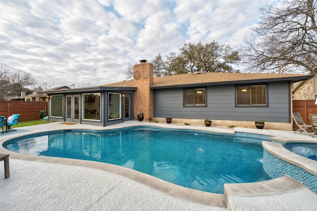 view of swimming pool with a patio area, a sunroom, and fence