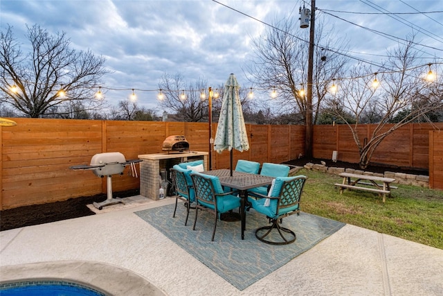 view of patio / terrace with a fenced backyard, a grill, and outdoor dining space