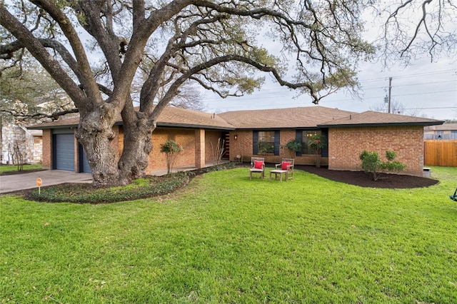 ranch-style home with a front yard, a garage, fence, and brick siding