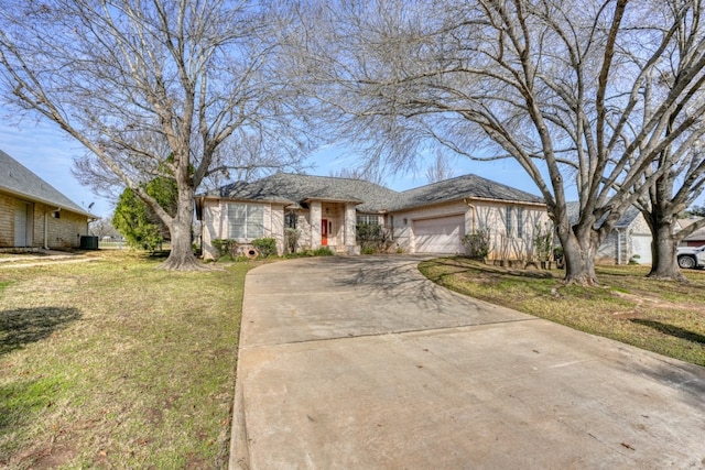 view of front of property featuring a garage and a front lawn