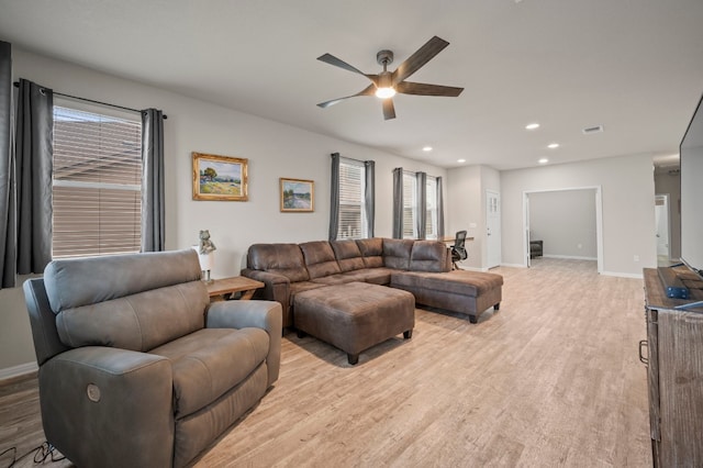 living room featuring light hardwood / wood-style floors and ceiling fan